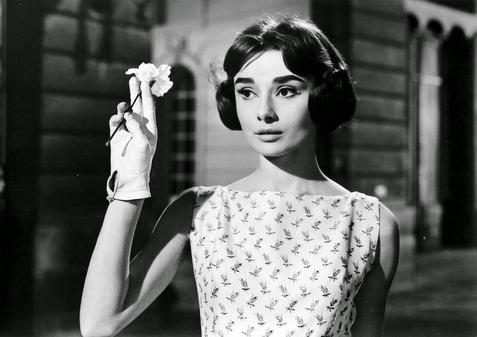 Audrey Hepburn as Ariane, holding Flannagan's lapel flower